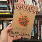 Ishmael book cover hold up in front of book case